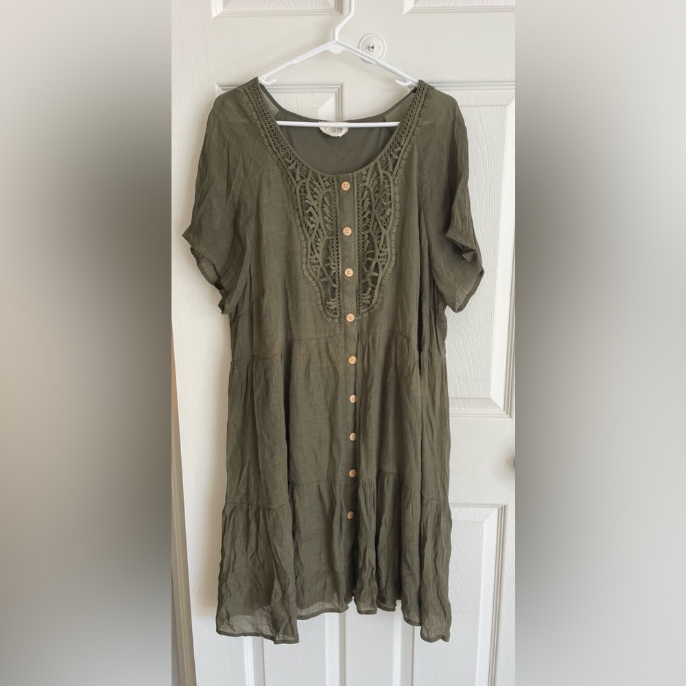 Short-sleeved olive green midi dress with lace details and beige buttons.